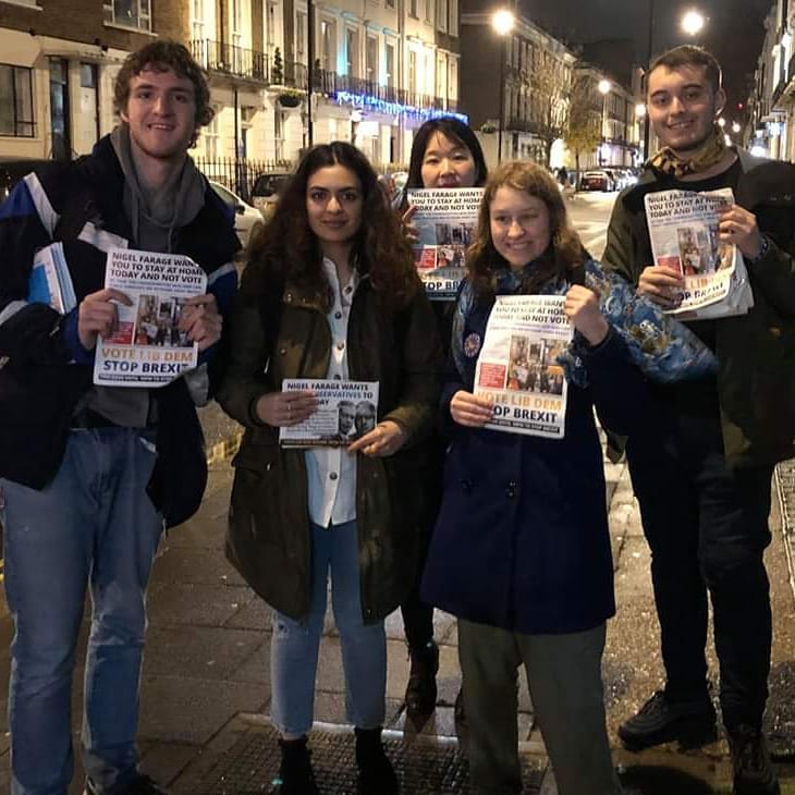 UCL Lib Dem members out campaigning, holding leaflets