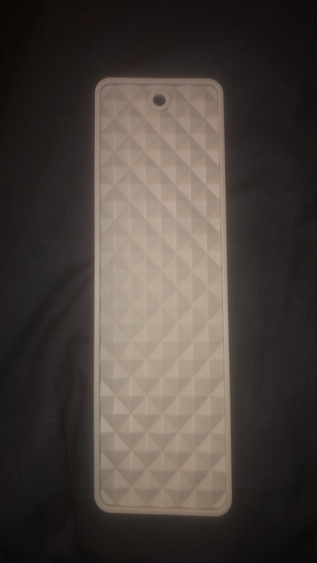 Front of mat. Raised diamond pattern. 