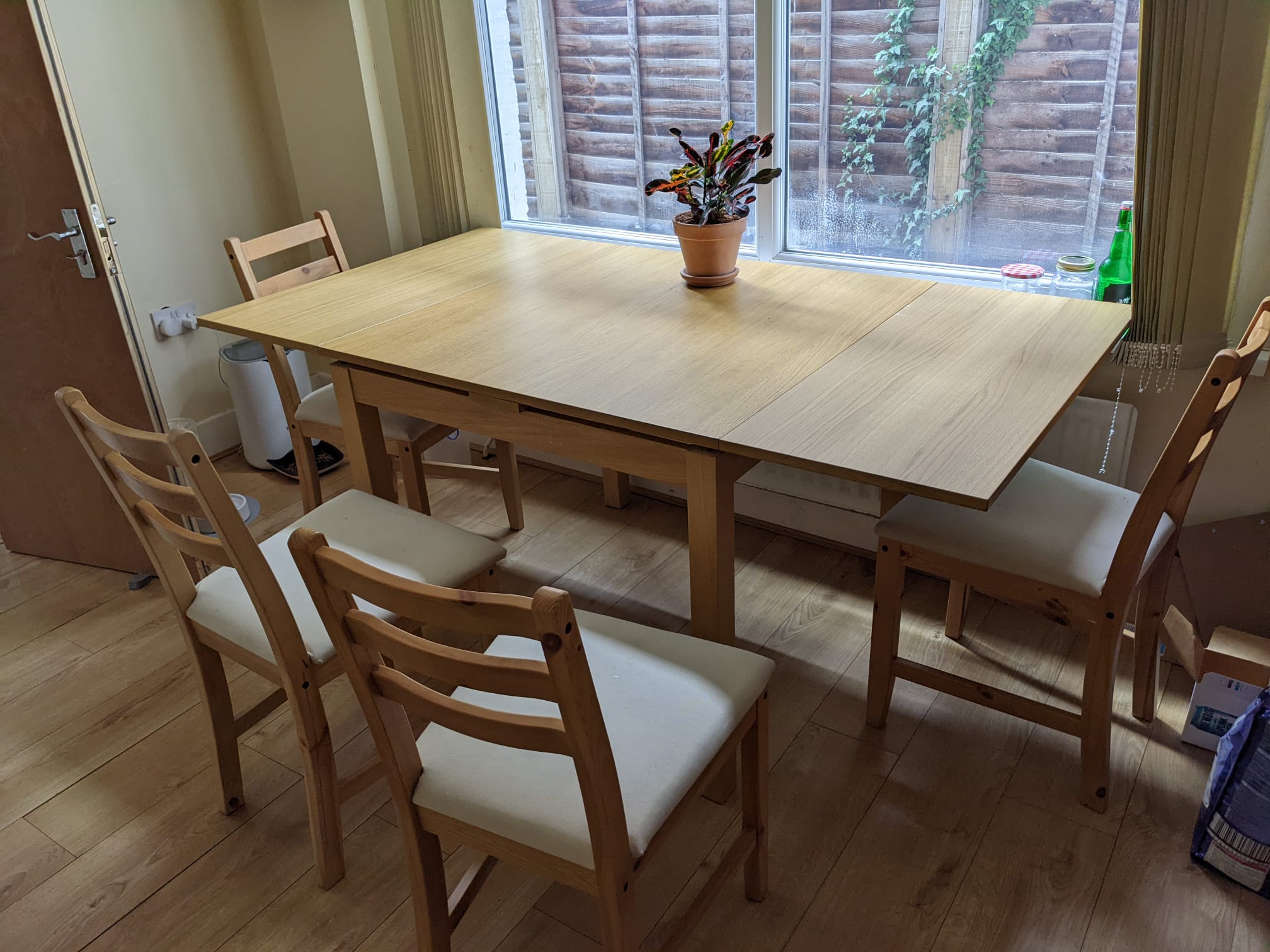 Wood dining table with leaves extending and four chairs