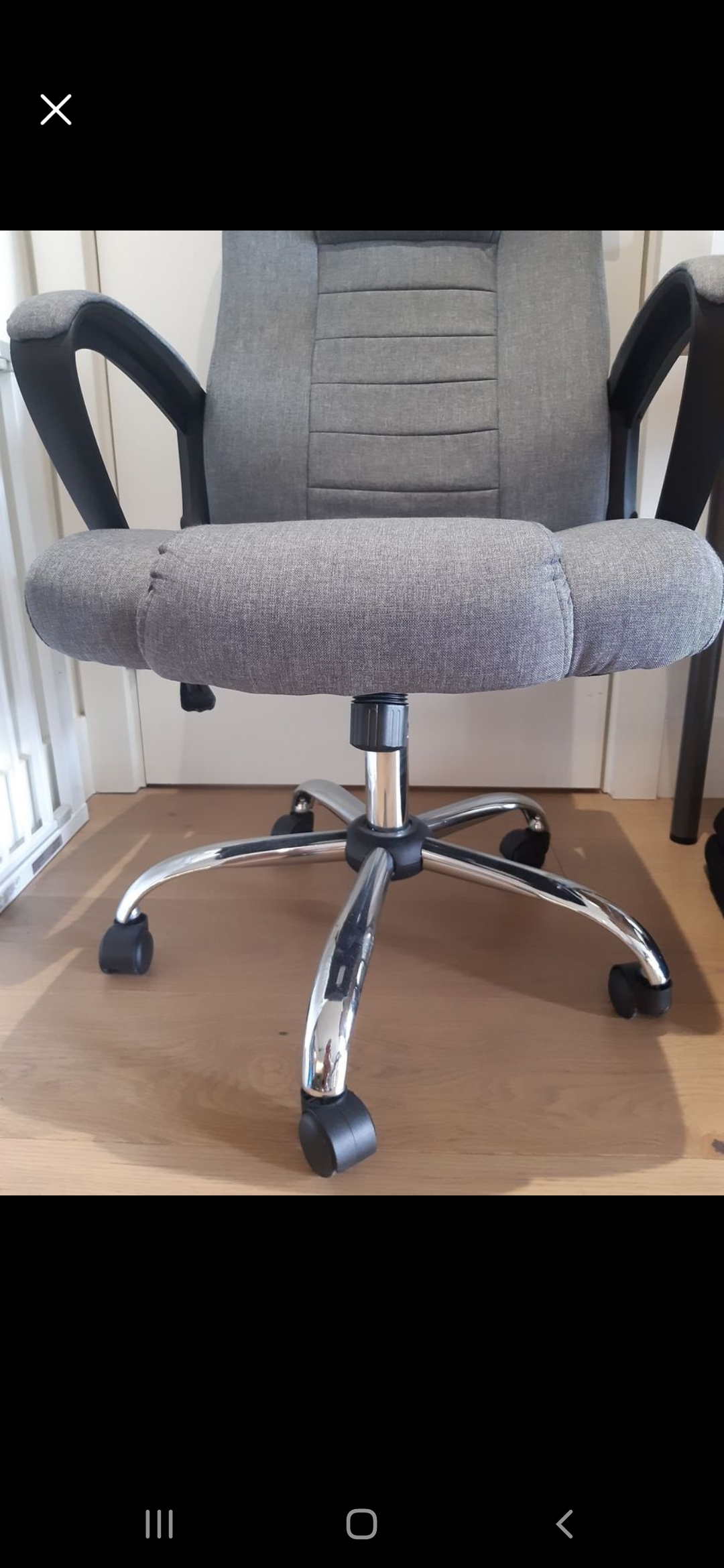 Picture shows gray ergonomic office chair.