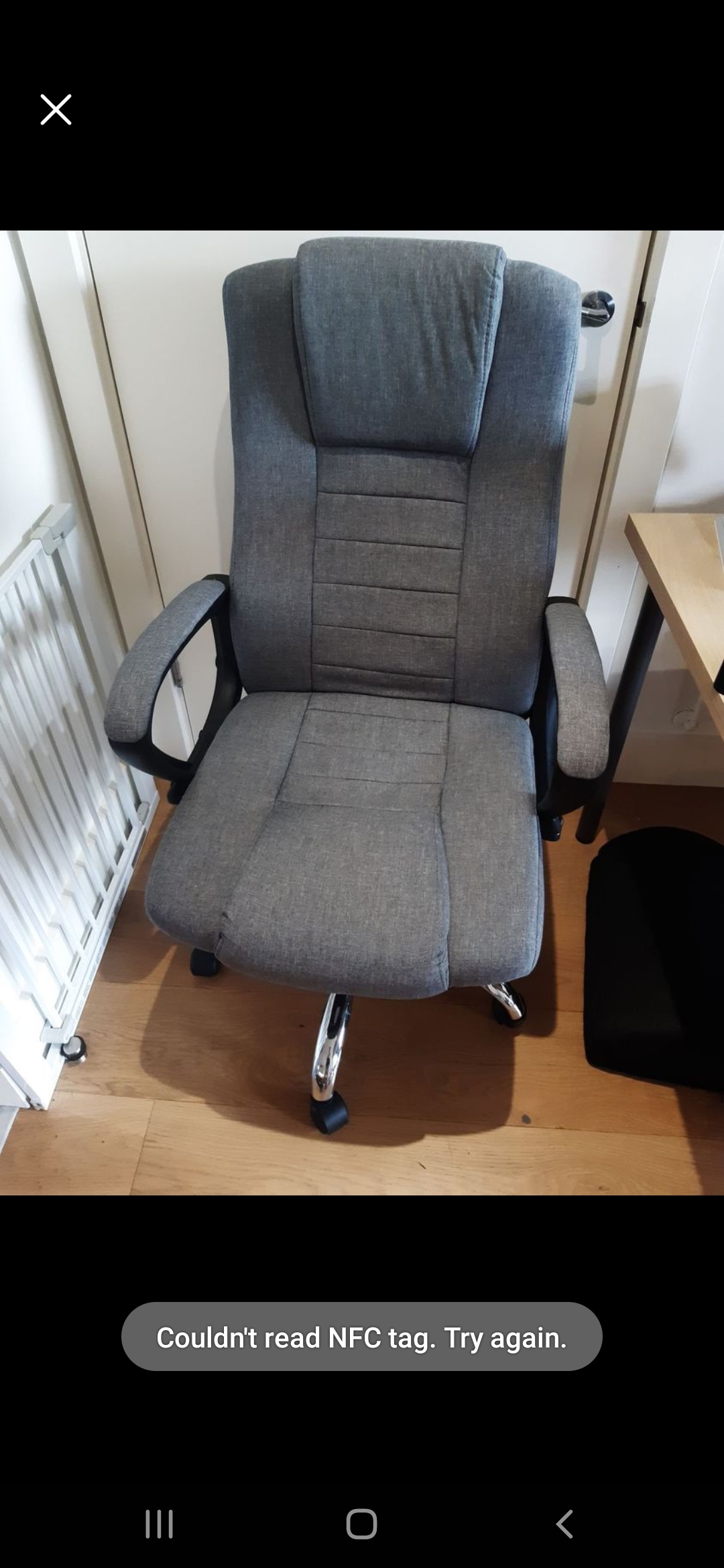 Picture shows gray ergonomic office chair.
