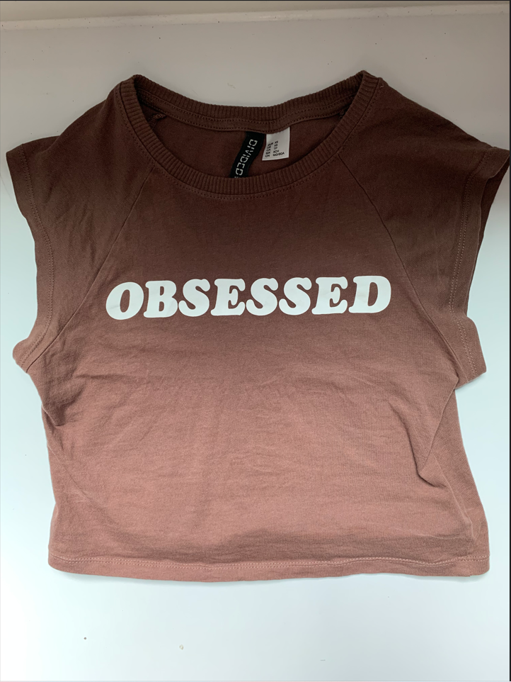 Brown crop top with word "OBSESSED" in white