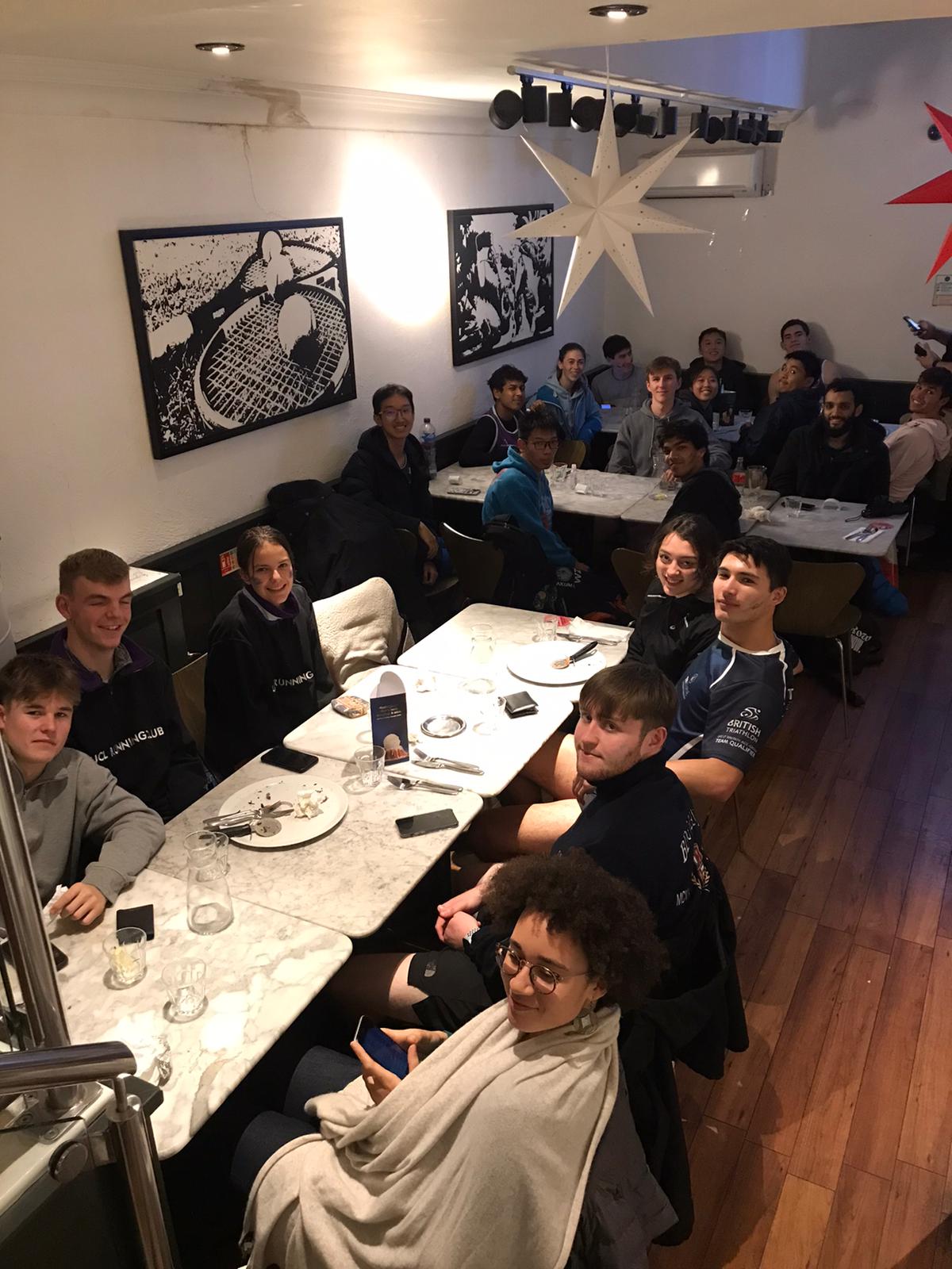 Group photo of runners at a pizza place
