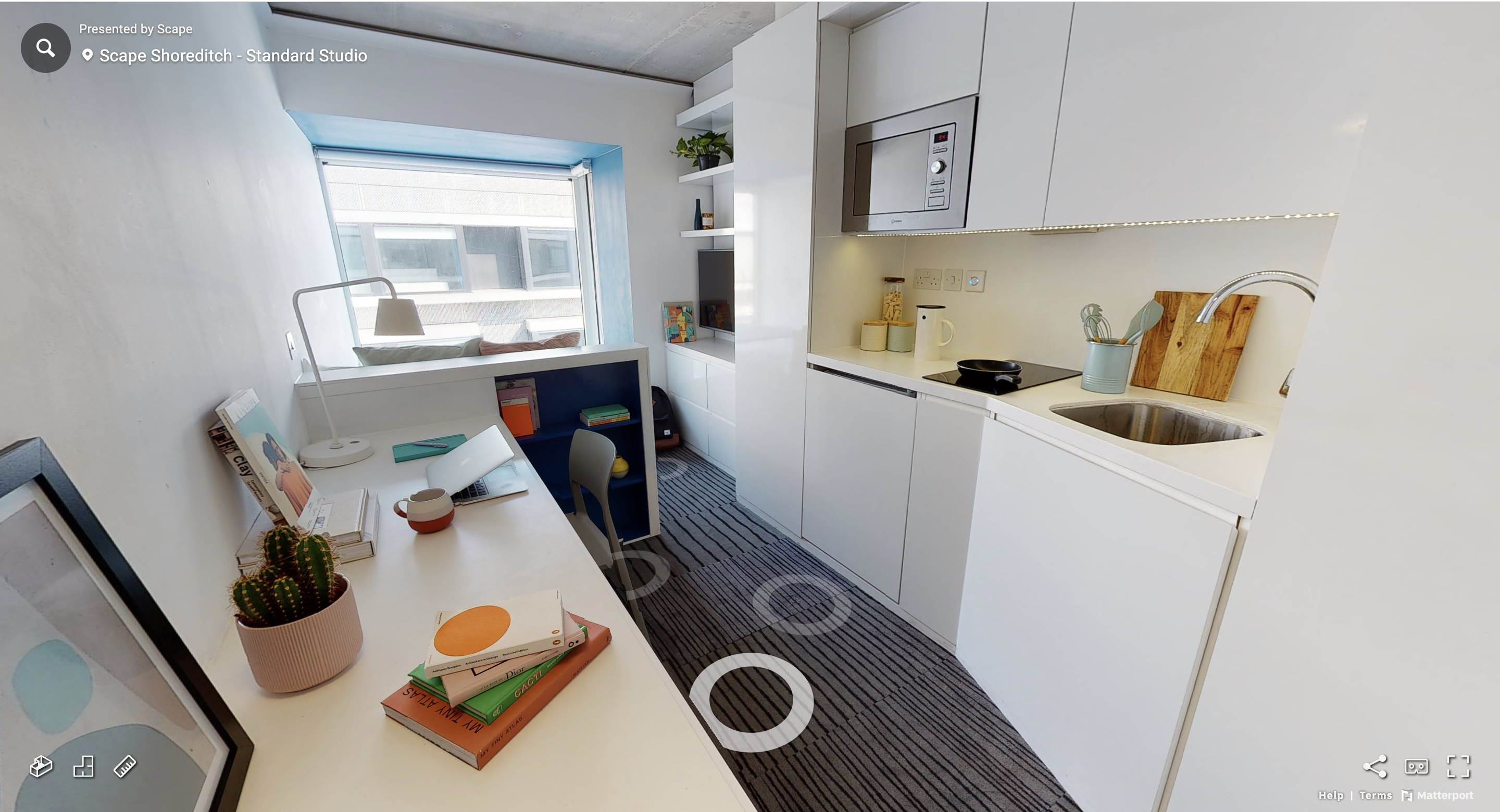 Room overview - dining table, study desk, bed, kitchenette.