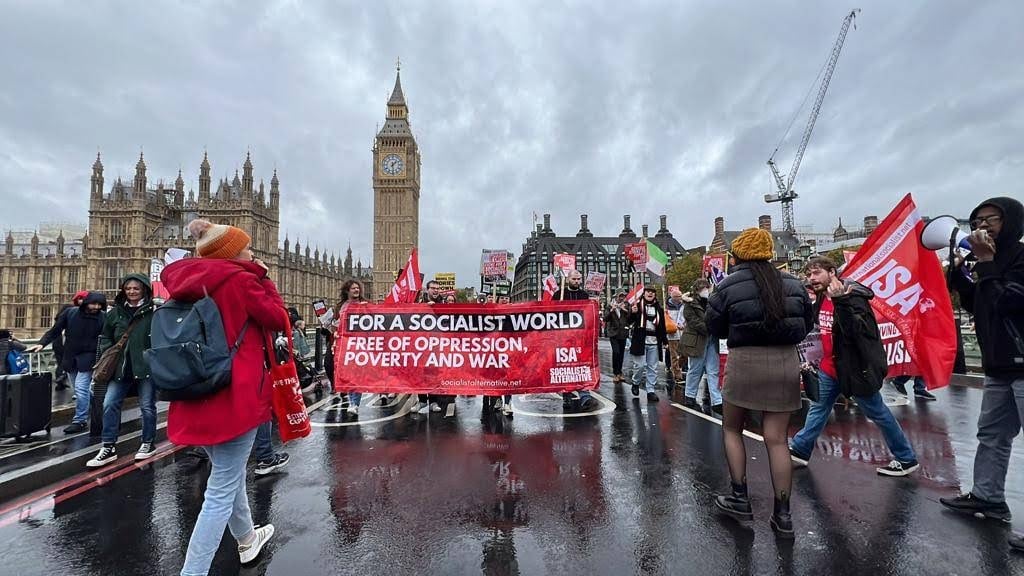 For a socialist world free of poverty, oppression, war, banner with protest held across Westminster Bridge
