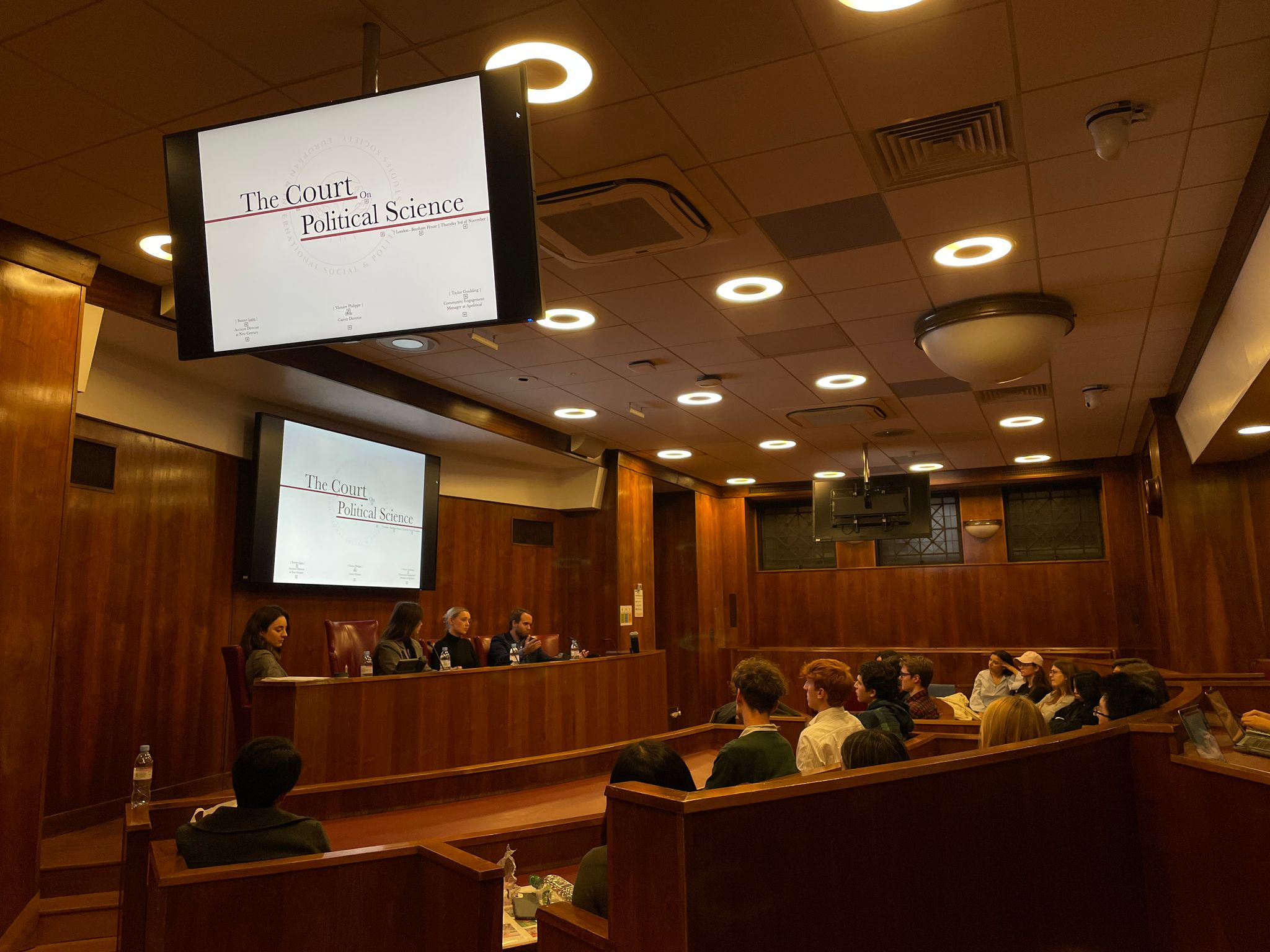 Image taken from EISPS Society's seminar on careers one can pursue as a political science student. Features four speakers sitting in a row on a raised platform (from New Century Media, Apolitical, as well as two hosts from the Society), as well as participants sitting in parliamentary-style seating at the Bentham House Moot Court.