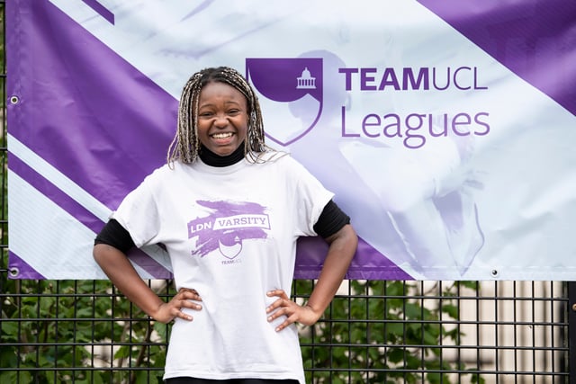 Student smiling in front of TeamUCL Banner