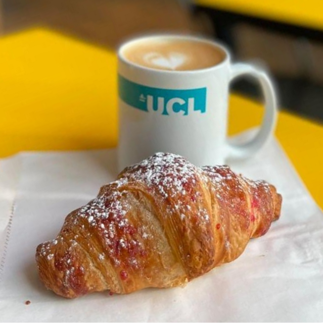 Coffee in a ceramic cup and croissant