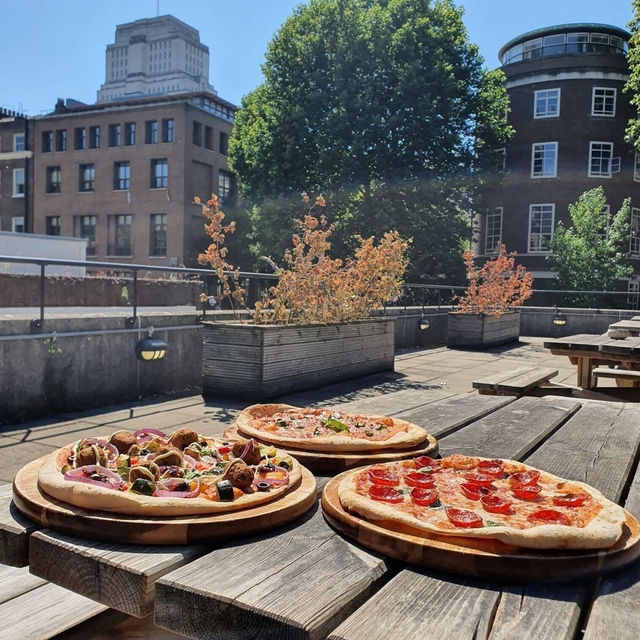 Three pizzas on the Institute patio