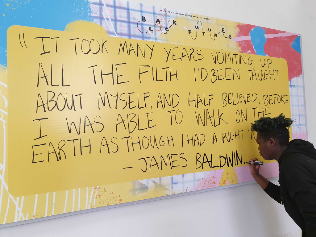 Sandy writing the James Baldwin quote on the exhibition board.
