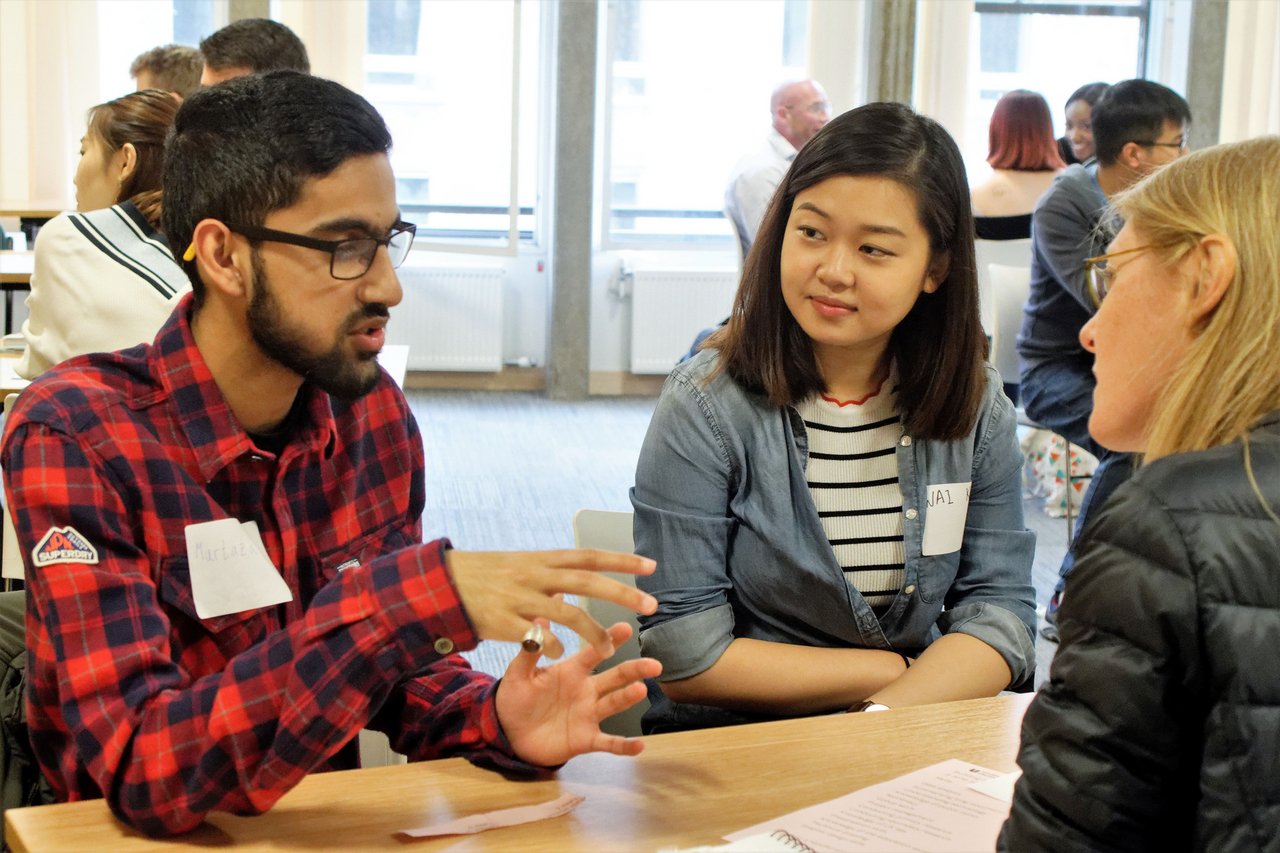 three student volunteers talking