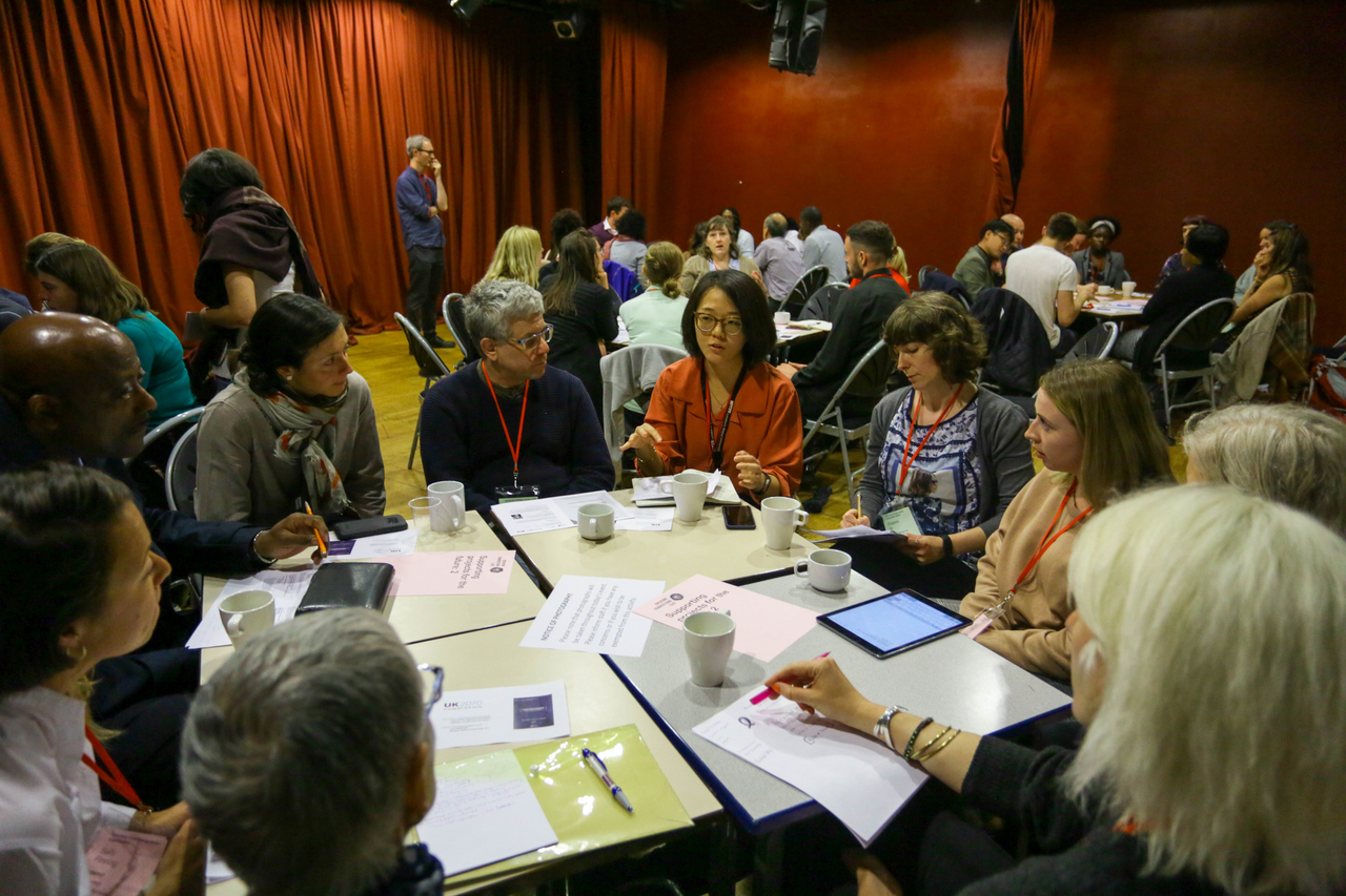 Group of people sat around table 
