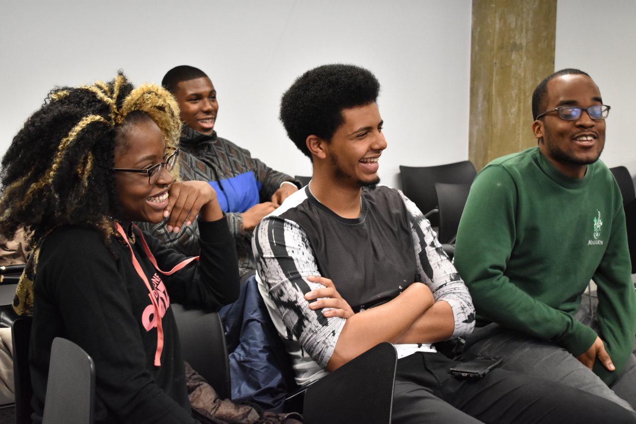 group of sitting students laughing