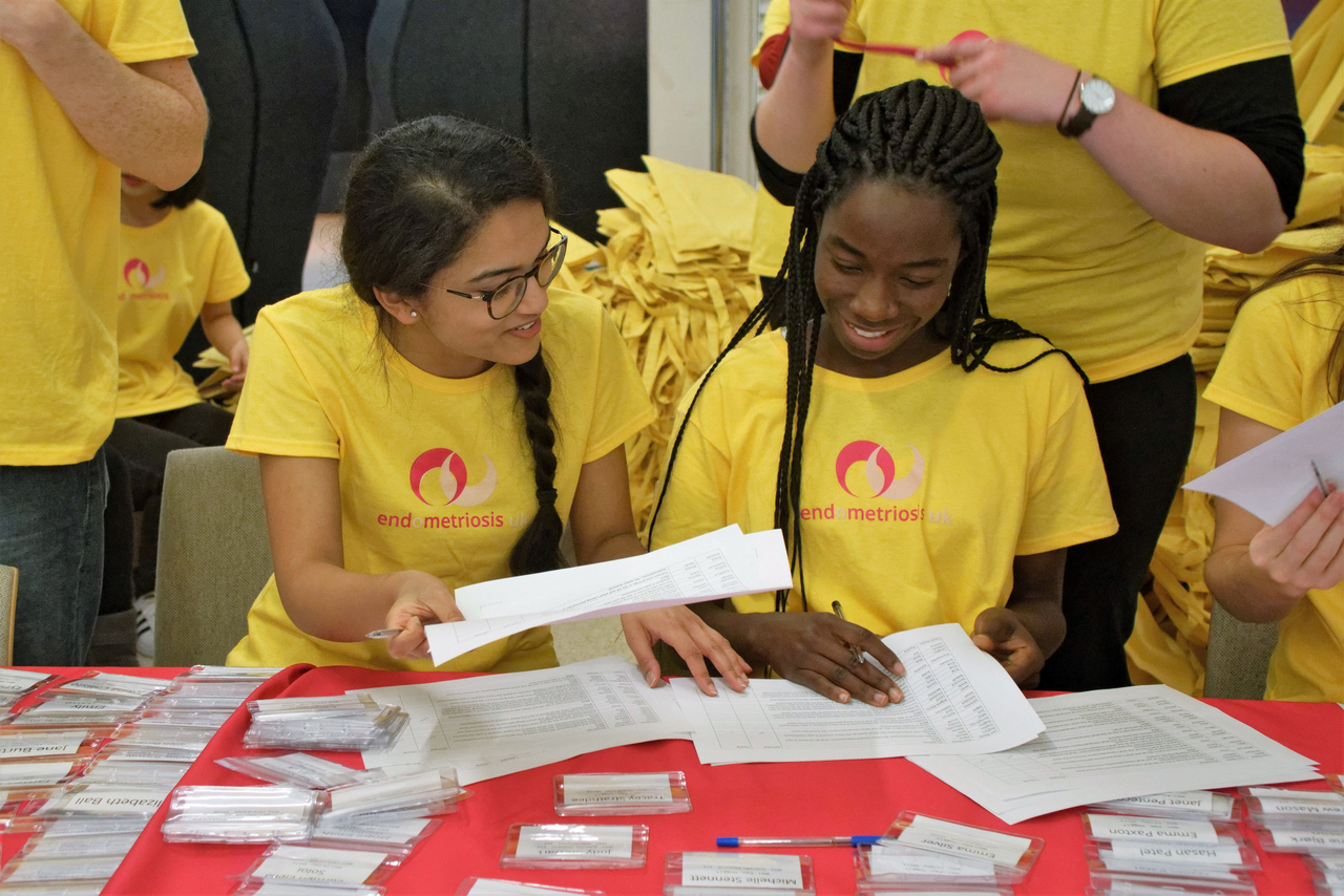 student volunteers in yellow endometriosis uk tee shirts