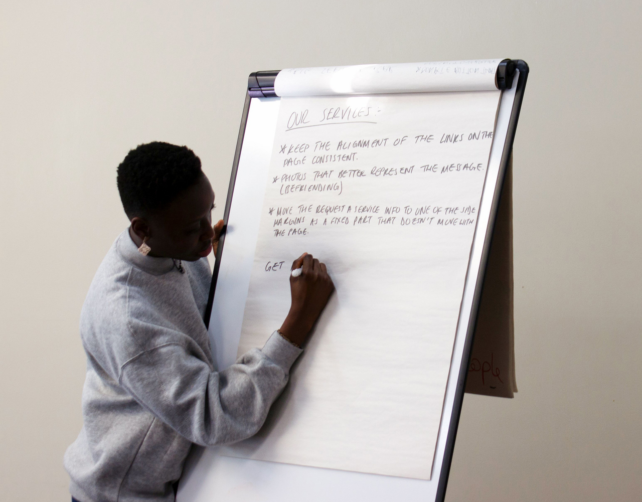 Student writing on flip chart