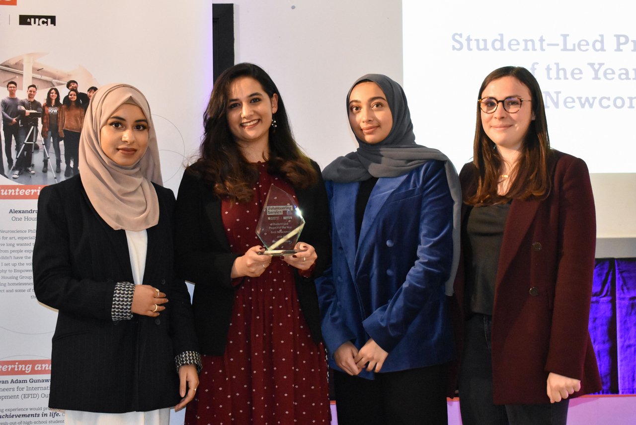group of female students standing holding award